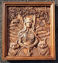 an intricately carved wooden plaque depicting a woman and two cats