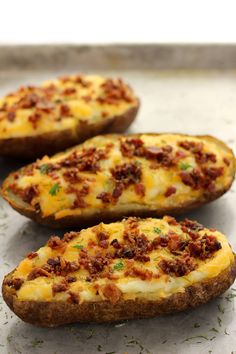 three baked potatoes sitting on top of a counter