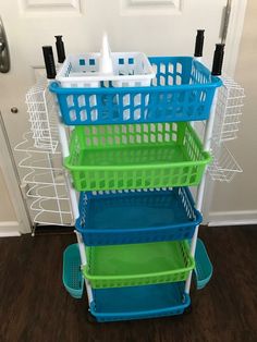 three plastic baskets stacked on top of each other in front of a door with the handles down