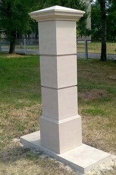 a tall white monument sitting in the middle of a park