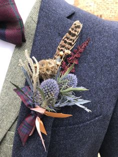 a man wearing a suit and tie with flowers in his lapel flower pinhole