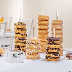 several donuts stacked on top of each other in front of boxes and napkins