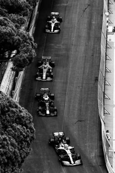 a group of cars driving down a race track