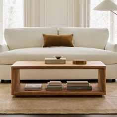 a living room with a white couch and coffee table