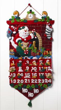 a christmas banner hanging on the wall with santa claus and other holiday decorations around it