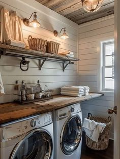 a washer and dryer in a small room with wood paneling on the walls