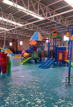 an indoor play area with water slides and toys