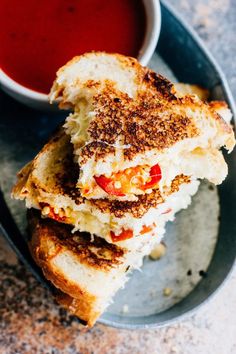 a grilled cheese sandwich with tomato sauce on the side