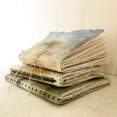 a stack of old books sitting on top of a table