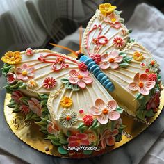 a cake decorated with flowers and a butterfly