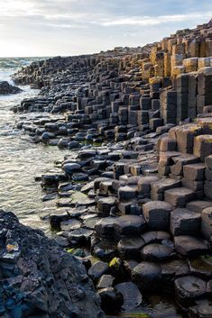 the giant rocks are lined up along the water's edge, and there is no image here to provide a caption for