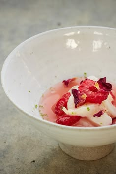 a white bowl filled with food on top of a table