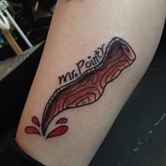 a person with a tattoo on their arm that says mitt point and has a piece of bacon in it