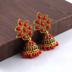 Overview These stylish Jhumki Earrings set from JewelryTrack will certainly leave you spellbound. These Jhumki Earrings set have an excellent finish and gives out an exquisite sense of style. If you are looking for an amazing Fashion Jewelry set for special occasions such as Anniversary, Engagement, Party, Wedding or for gifting , then your search ends here.  Item Description: The look is stunning and preciously suitable for all kinds of dressy occasions. Metal: Brass OCCASION: PARTY WEAR , WEDD Red Earrings For Puja And Festivals, Red Temple Jewelry Jhumkas For Puja, Red Temple Jewelry Jhumkas For Festivals, Red Temple Jewelry Jhumkas For Celebration, Red Earrings For Puja And Diwali, Red Jhumkas With Latkans For Puja, Red Latkans Jhumkas For Puja, Red Latkans Earrings For Diwali, Red Bollywood Earrings For Eid