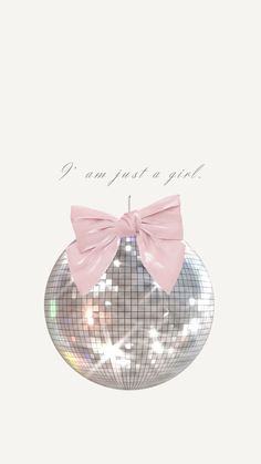 a silver disco ball with a pink bow on the top and words i am just a girl