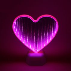 a purple heart shaped light on top of a table