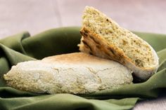 two pieces of bread sitting on top of a green cloth