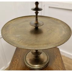 two tiered cake plate on top of a wooden table