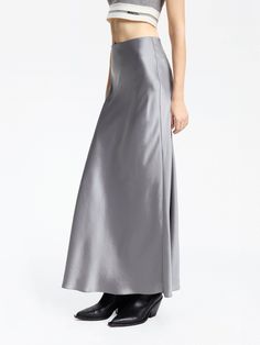 MO&Co. Women's High Rise Satin Maxi Skirt Introducing our satin skirt, crafted from a luxurious blend of acetate and polyester. The high waist and flowing silhouette are effortlessly elegant, while the convenient side zipper allows for easy wear. Create a chic and casual look by pairing it with a tank top or cozy sweater. Features : - High waist, flowy maxi silhouette- Ruched pleated details on the back- Soft and smooth triacetate blend materials Code: MBD1SKT033The back length of size S is 94.5 Sleek Formal Skirt For Spring, Sleek Formal Spring Skirt, Relaxed Fit Satin Maxi Skirt, Spring Full-length Satin Skirt, Silk Solid Color Flared Maxi Skirt, Fitted Silk Flared Maxi Skirt, Sleek Midi Skirt Bottoms For Evening, Elegant Silk Full Skirt Bottoms, Chic Formal Satin Skirt