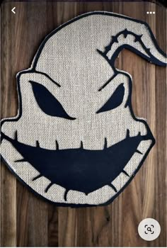 a close up of a door mat with an evil face on it