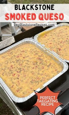 two pans filled with food sitting on top of an outdoor grill