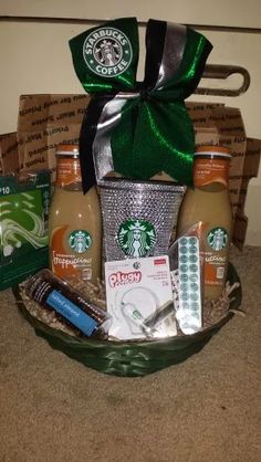 the starbucks gift basket is filled with coffee, cookies and other items