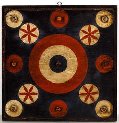 an abstract painting with red, white and blue circles on black paper in the center