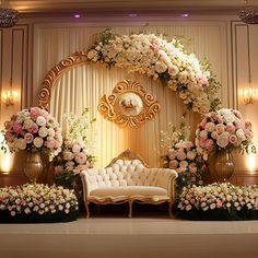 a floral decorated stage set up for a wedding ceremony with white and pink flowers on it