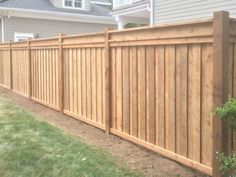 a wooden fence in front of a house