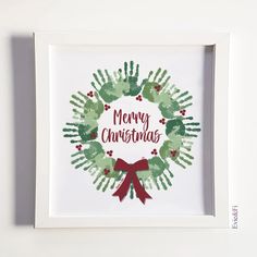 a handprinted christmas wreath with the words merry christmas in red, green and white