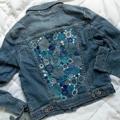 a denim jacket with buttons and circles on it