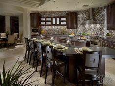 a kitchen filled with lots of counter top space next to a dining room table and chairs