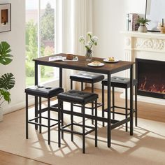 a dining table with four stools and a fire place in the corner next to it