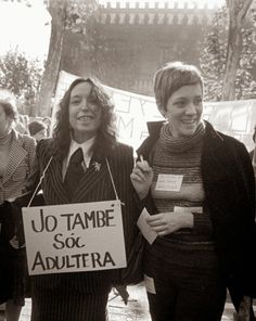 two women standing next to each other in front of a crowd holding signs that read jo tambe so adultra