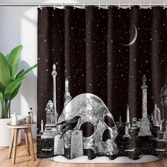 a black and white shower curtain with a skull on the ground in front of it