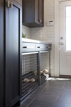 a dog kennel in the corner of a kitchen next to a door and window