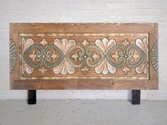 a wooden bench sitting on top of a cement floor