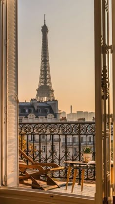 the eiffel tower is seen through an open window