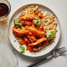 a white plate topped with chicken and rice