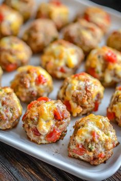 mini meatballs with cheese and tomatoes on a tray