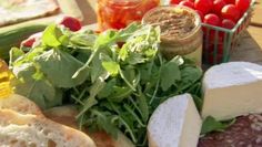 an assortment of food including bread, cheese and vegetables