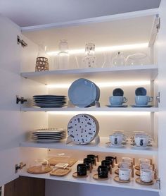 the shelves are filled with dishes and plates