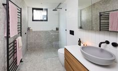 a bathroom with a sink, mirror and towel rack