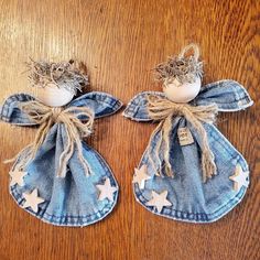 two denim angel ornaments on a wooden table