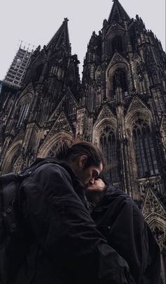 a man standing in front of a large cathedral