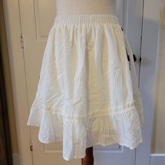 Fun, Flirty, & Flippy, This Skirt Is Just Begging To Be Skipped In! Soft Vanilla White Elastic Waistband-Great Stretch Ruffled Detailing Fully Lined Lightweight Flowy Fit Is Generous, Due To The Great Stretch Afforded By The Waistband. Nwt, No Flaws To Note. Approximate Measurements: Waist: 11.75" Stretches To: 20" Length: 17.5" Don't Hesitate To Make An Offer! Bin#2 White Mini Skirt With Elastic Waistband For Daywear, White Lined Tiered Skirt Petticoat, White Tiered Lined Petticoat, White Lined Skirt Petticoat, White Lined Skirted Petticoat, White Mini Skort With Ruffle Hem, White Mini Skirt Petticoat With Ruffles, White Ruffle Hem Mini Skort, White Stretch Skirt With Ruffles