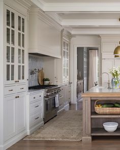 a kitchen with white cabinets and an island in the middle of the room is shown