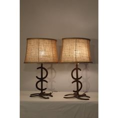 two lamps sitting on top of a table next to each other