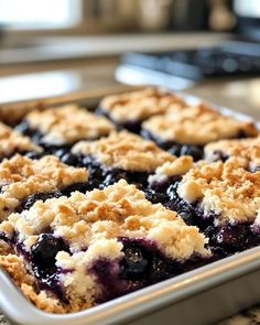 a close up of a blueberry pie in a pan on a counter top,