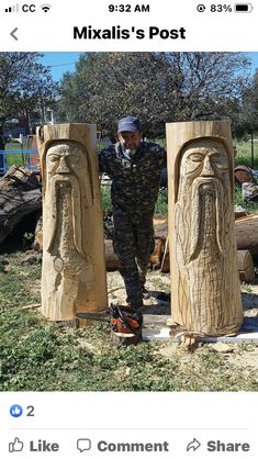 a man standing next to two wooden statues